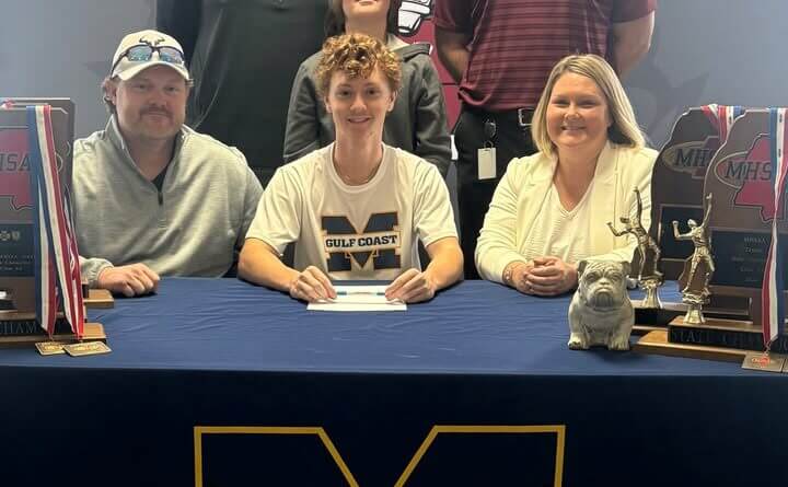 Bradyn Bowman (center) is surrounded by family and coaches as he signs a scholarship to play tennis